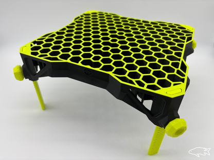 Bottom-sitting frag rack with sturdy legs in a saltwater tank holding vibrant coral frags